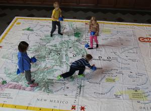 Elementary students explore a walkable map of Colorado.