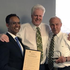 David Thompson receives his award from Faculty Council Chair Ravinder Singh and CU President Bruce Benson.