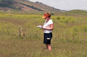 Hartley in the field, sampling plants on prairie dog colonies.