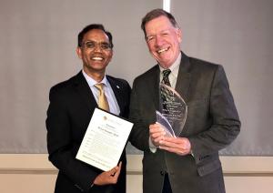 William Kaempfer, right, receives the Faculty Council's Administrator of the Year Award from Chair Ravinder Singh.