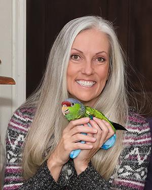 Rennison and one of her pet parrots.