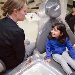 School of Dental Medicine works with a youngster