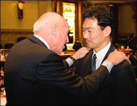 Sen. Rollie Heath thanks Norio Fukami, M.D., for saving his life.