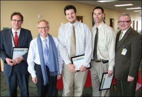University of Colorado Hospital President and CEO Bruce Schroffel, second from left, and Chief Operating Officer John Harney, far right, with Rock Solid Economics award winners, from left, Michael MacLauchlan, Chad Chenoweth and Steve Nordstrom.