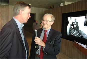 Colorado Governor John Hickenlooper talks with the University of Colorado School of Medicine’s Curt Freed for a video crew from the CU Anschutz Medical Campus during opening festivity for the Clyfford Still Museum. Nearly all the work by Still, in photo on wall, is housed at the gallery that opens to the public Saturday.