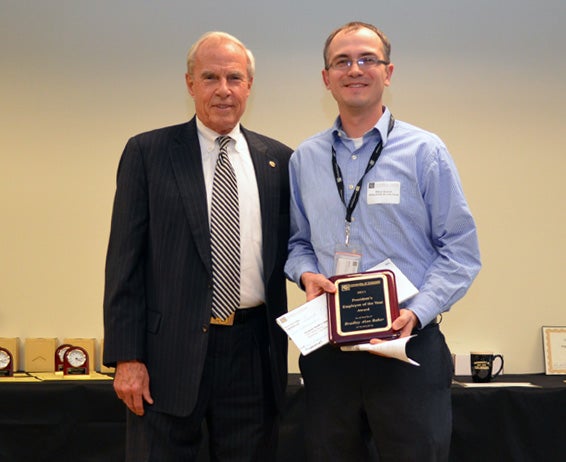 President Bruce Benson presents the Employee of the Year Award 