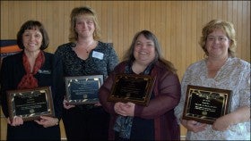 From left, Alexis Kelly, Stephanie Hanenberg, Lisa Province and Donna Maes display their service excellence awards at the All Staff Council Conference on Friday, April 16. They were honored for exceptional volunteer dedication to their department, campus and community. [Photo/Caroline Seib] 